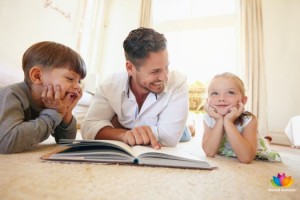 Father with two kids reading a story book.