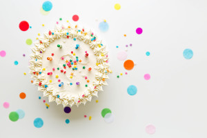 75083470 - birthday cake with colorful candles