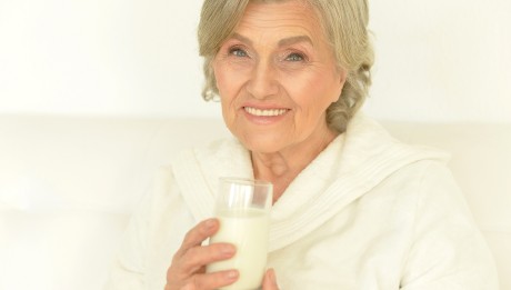 Seniour woman drinks milk