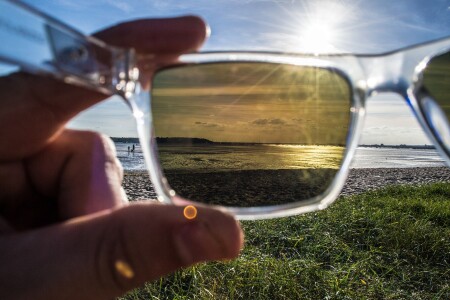 View through polarized sunglasses of harbour, ocean and beach