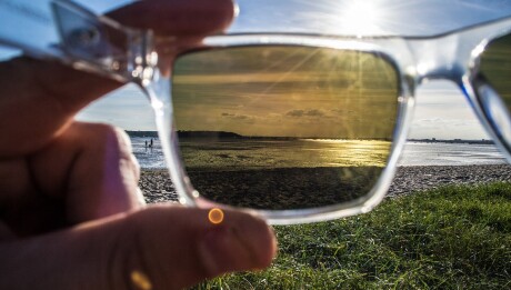 View through polarized sunglasses of harbour, ocean and beach