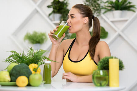 Energy drink. Fit girl drinking healthy detox cocktail