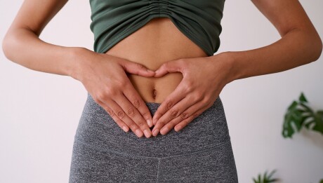 Close up of a multi-ethnic woman's hands on her stomach