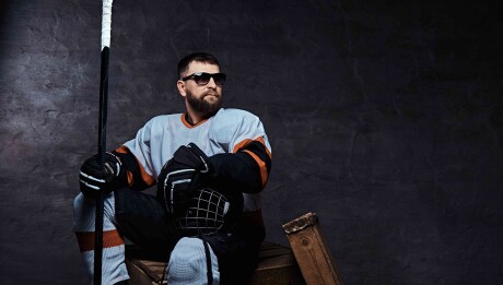 Stylish,Bearded,Hockey,Player,Wearing,Full,Sports,Equipment,And,Sunglasses